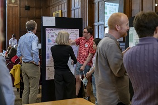 People looking at APUC posters 27 Sep 2023